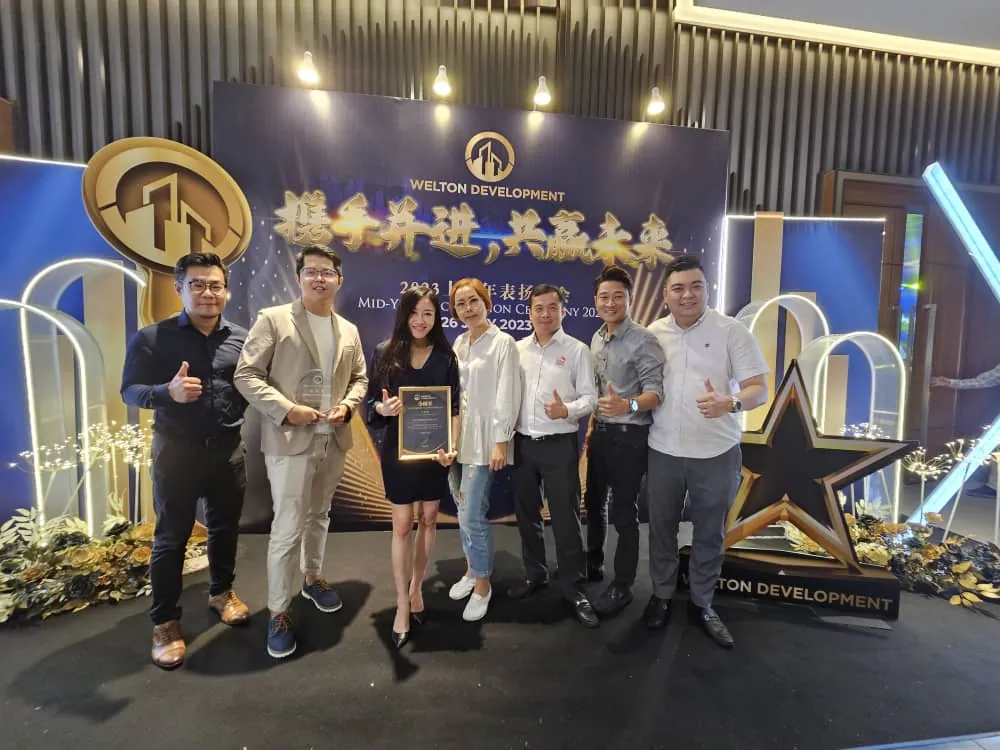Eve Ang’s team receiving awards on stage at a developer appreciation event