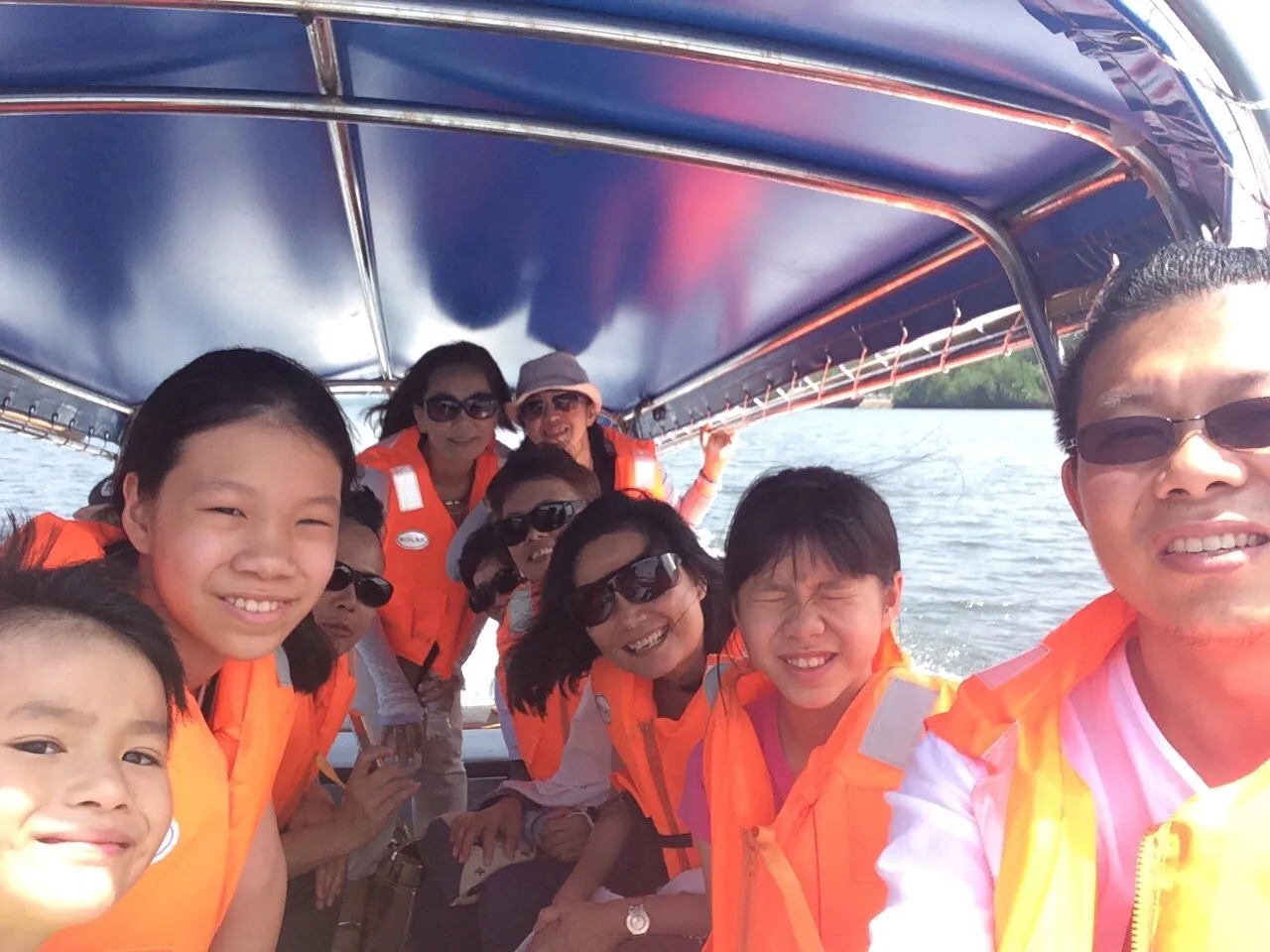 Eve Ang and colleagues in life jackets on a boat site visit in 2015
