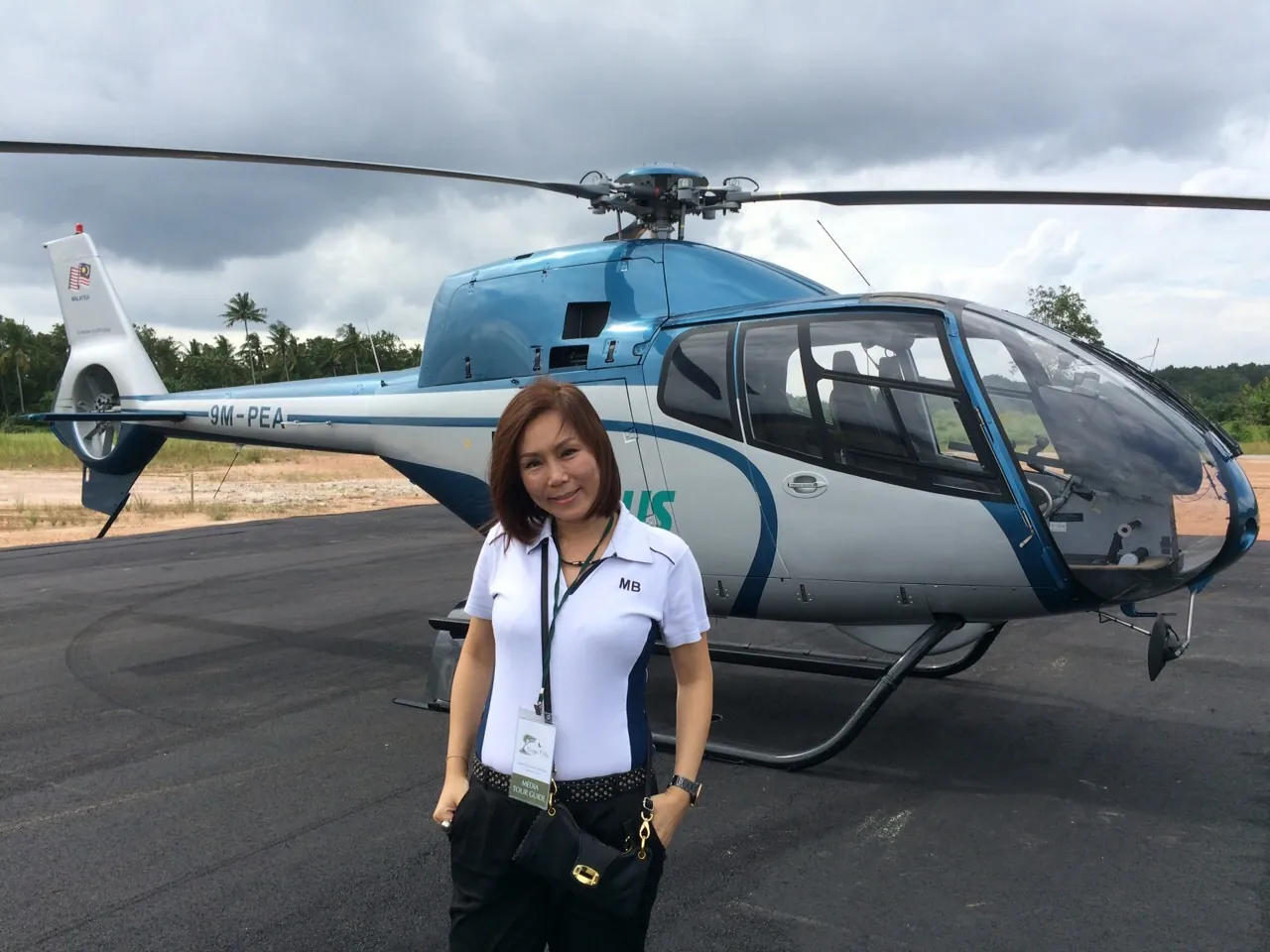 Eve Ang in 2015 standing in front of a helicopter before a site tour, early in her real estate journey