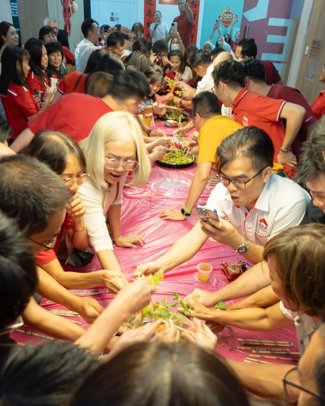 The team tossing lou sang together at Chinese New Year